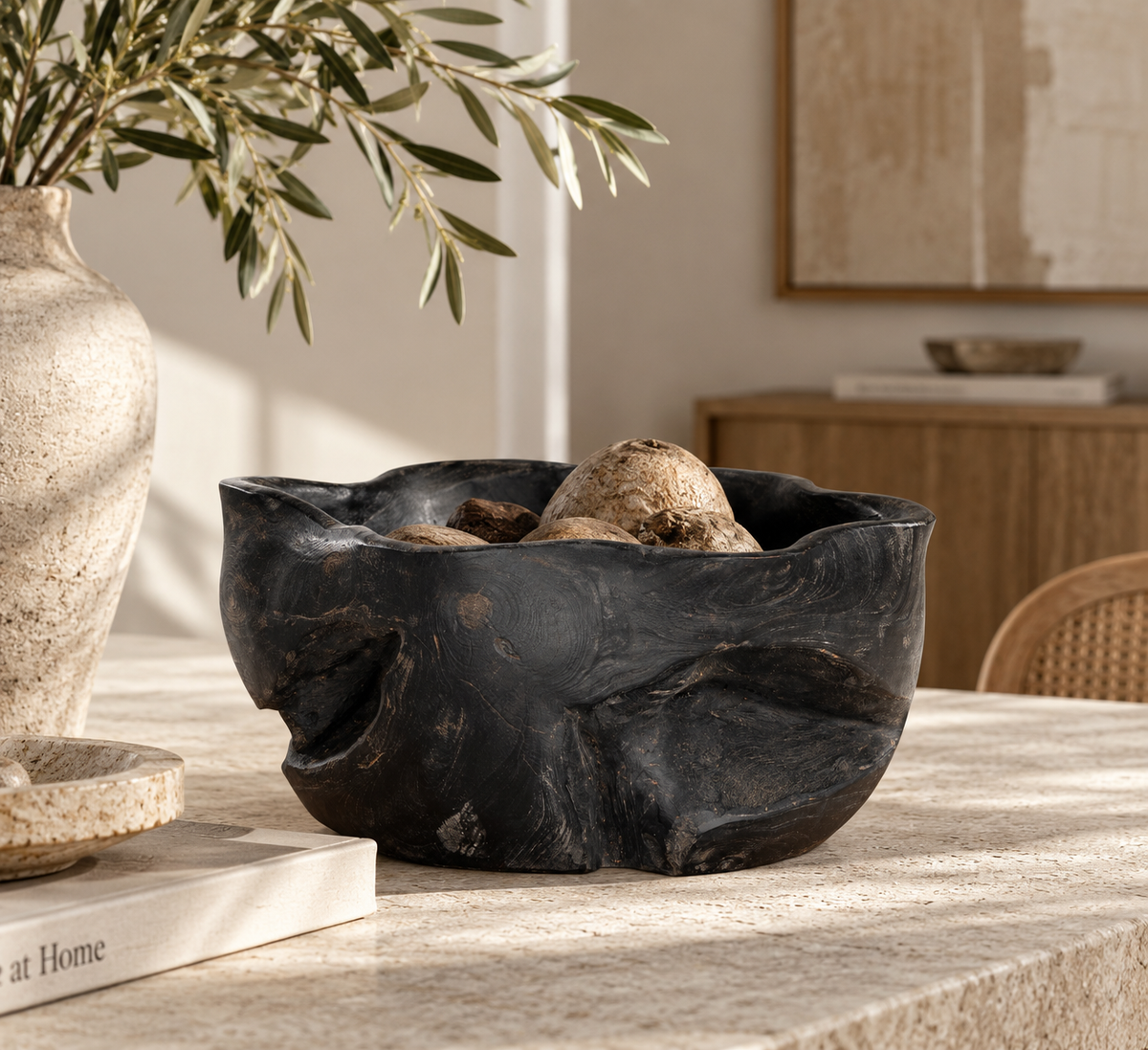 Sodwana Shou Sugi Ban Teak Root Bowl with a dark textured finish, styled as a centrepiece on a natural stone dining table.