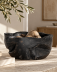 Sodwana Shou Sugi Ban Teak Root Bowl with a dark textured finish, styled as a centrepiece on a natural stone dining table.