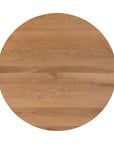 A beautifully crafted round dining table made from solid oak, featuring a minimalist conical base for a timeless and contemporary design