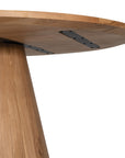 A beautifully crafted round dining table made from solid oak, featuring a minimalist conical base for a timeless and contemporary design