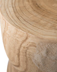 A sculptural solid timber stool with a curved silhouette, showcasing natural wood grain patterns. Versatile as a side table or additional seating, perfect for organic and modern interiors