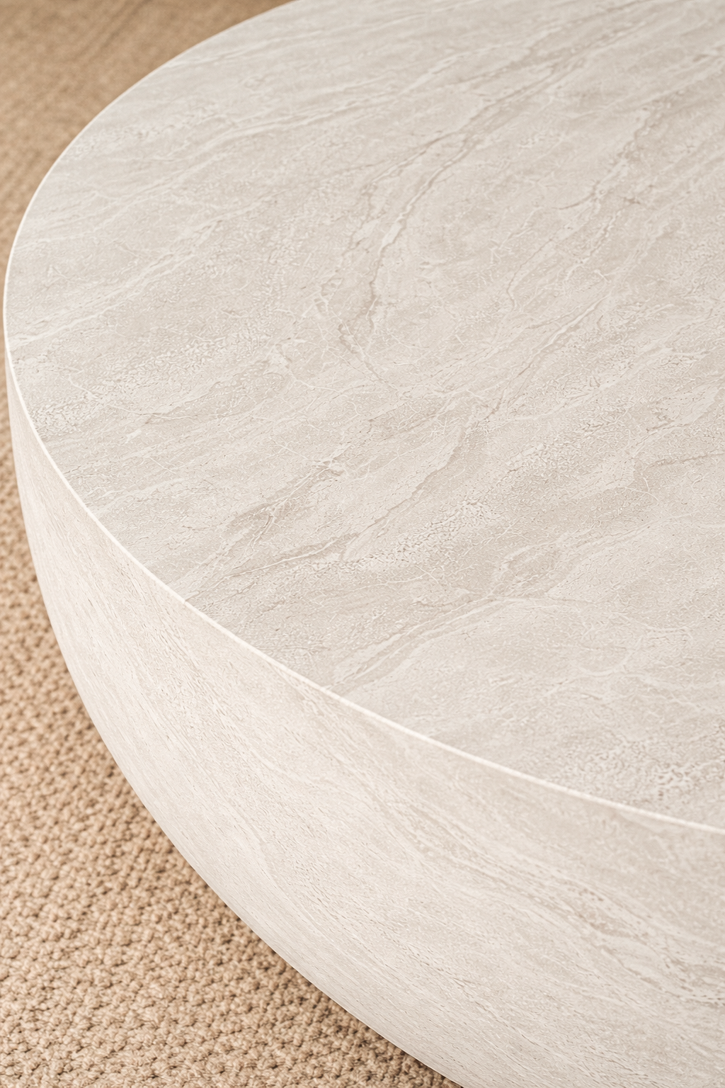 Tabati coffee table in eggshell hydro dipped finish with rounded low profile form styled in a soft neutral living room.