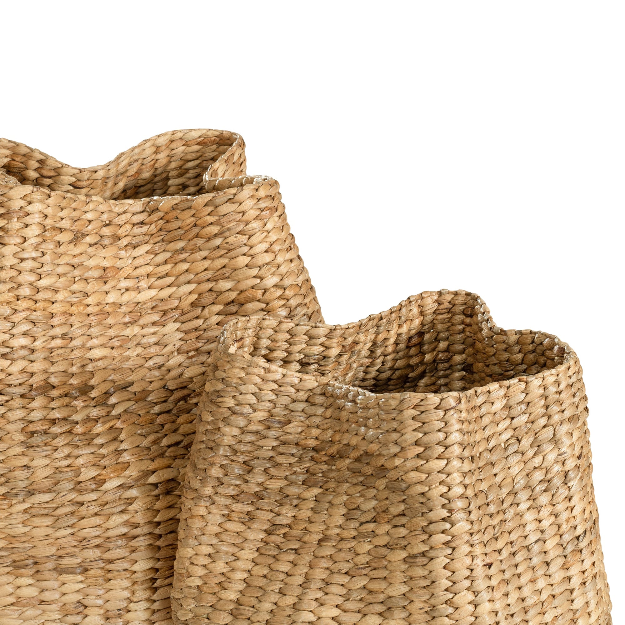 Talura basket in natural handwoven seagrass with organic rounded shape and softly structured open tops.