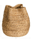 Talura basket in natural handwoven seagrass with organic rounded shape and softly structured open tops.