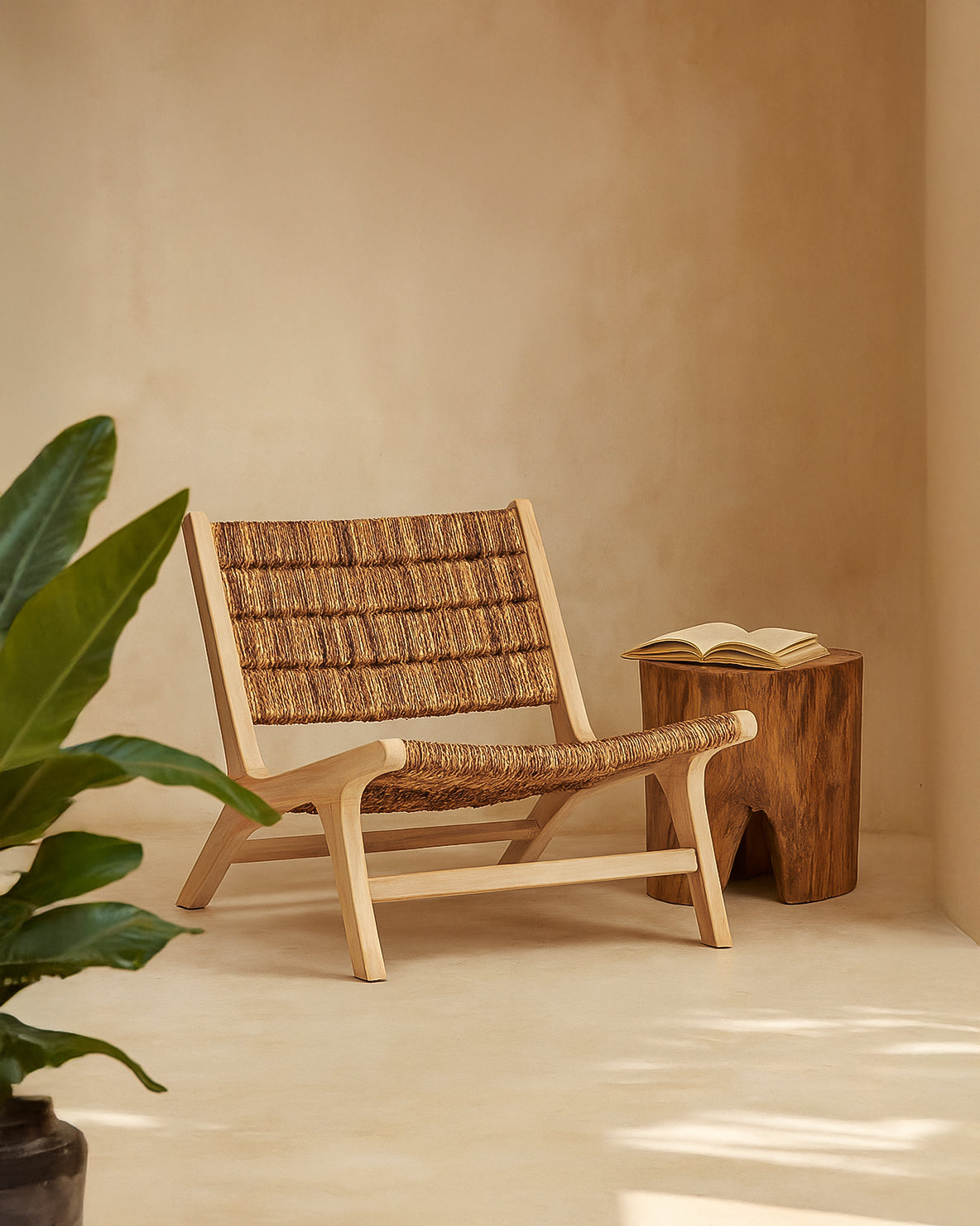 Tanza Teak Occasional Chair crafted from solid teak with handwoven banana bark seat and backrest, styled in a warm neutral interior with timber side table and greenery