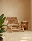 Tanza Teak Occasional Chair crafted from solid teak with handwoven banana bark seat and backrest, styled in a warm neutral interior with timber side table and greenery