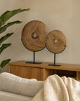 Tata Decorative Discs handcrafted from teak timber displayed on black metal stands, styled on a timber sideboard in a modern neutral living room
