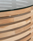 The Kulala Living Teak and Glass Coffee Table features a beautifully crafted open-weave teak base with a round glass top. This contemporary design blends natural warmth with modern elegance, making it a stylish centrepiece for any living space.