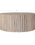 A round coffee table crafted from natural teak branches, arranged in a drum-style design. The organic texture and neutral tones make it a statement piece for coastal and contemporary interiors.