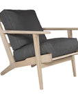 Kulala Living teak lounge armchair with plush charcoal cushions, featuring a modern, relaxed silhouette. Designed for comfort and timeless style in contemporary and coastal interiors