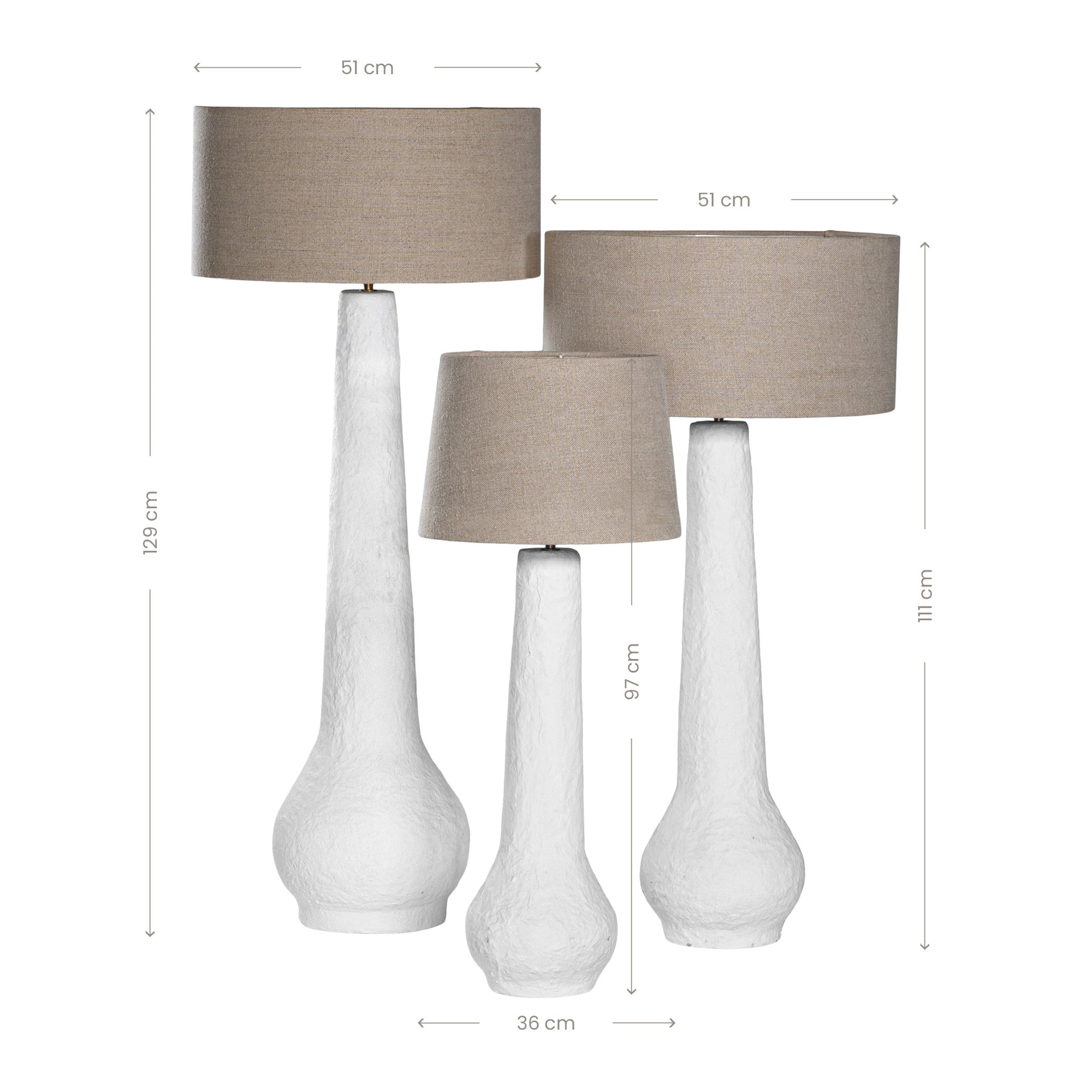 A set of three textured white table lamps with elongated sculptural bases and neutral linen shades, adding a refined and organic touch to any interior space