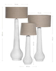 A set of three textured white table lamps with elongated sculptural bases and neutral linen shades, adding a refined and organic touch to any interior space