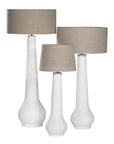 A set of three textured white table lamps with elongated sculptural bases and neutral linen shades, adding a refined and organic touch to any interior space