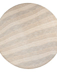 A luxurious round dining table crafted from natural travertine stone, featuring a sculptural pedestal base and smooth, polished finish. Perfect for contemporary and minimalist interiors