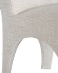 Contemporary arched dining chair upholstered in natural fabric, featuring sculptural curves and modern silhouette for refined dining spaces