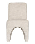 Contemporary arched dining chair upholstered in natural fabric, featuring sculptural curves and modern silhouette for refined dining spaces