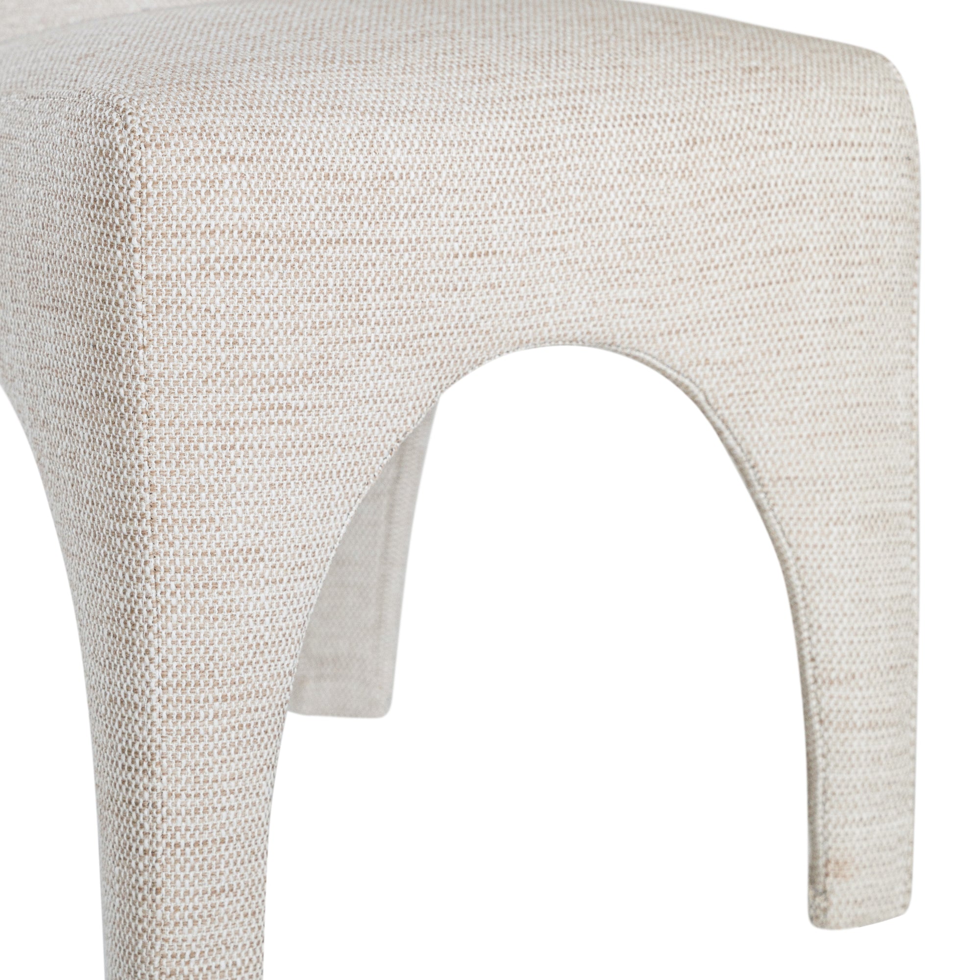 Contemporary arched dining chair upholstered in natural fabric, featuring sculptural curves and modern silhouette for refined dining spaces