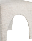 Contemporary arched dining chair upholstered in natural fabric, featuring sculptural curves and modern silhouette for refined dining spaces