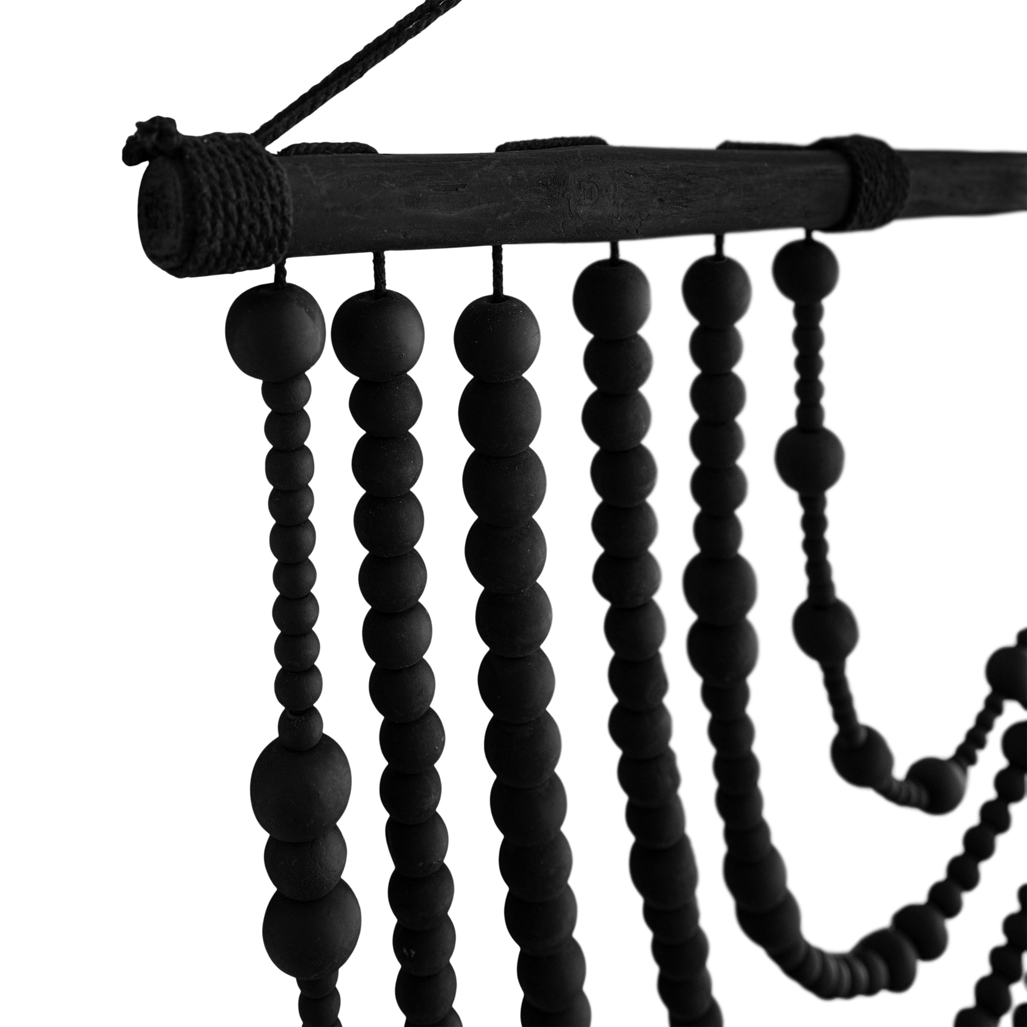 Black wooden beaded wall hanging with layered strands, creating a bold decorative statement for modern interiors