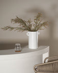 Stylish woven bar stool with a neutral-toned rope seat and a sleek white metal frame, perfect for contemporary kitchen or outdoor bar settings