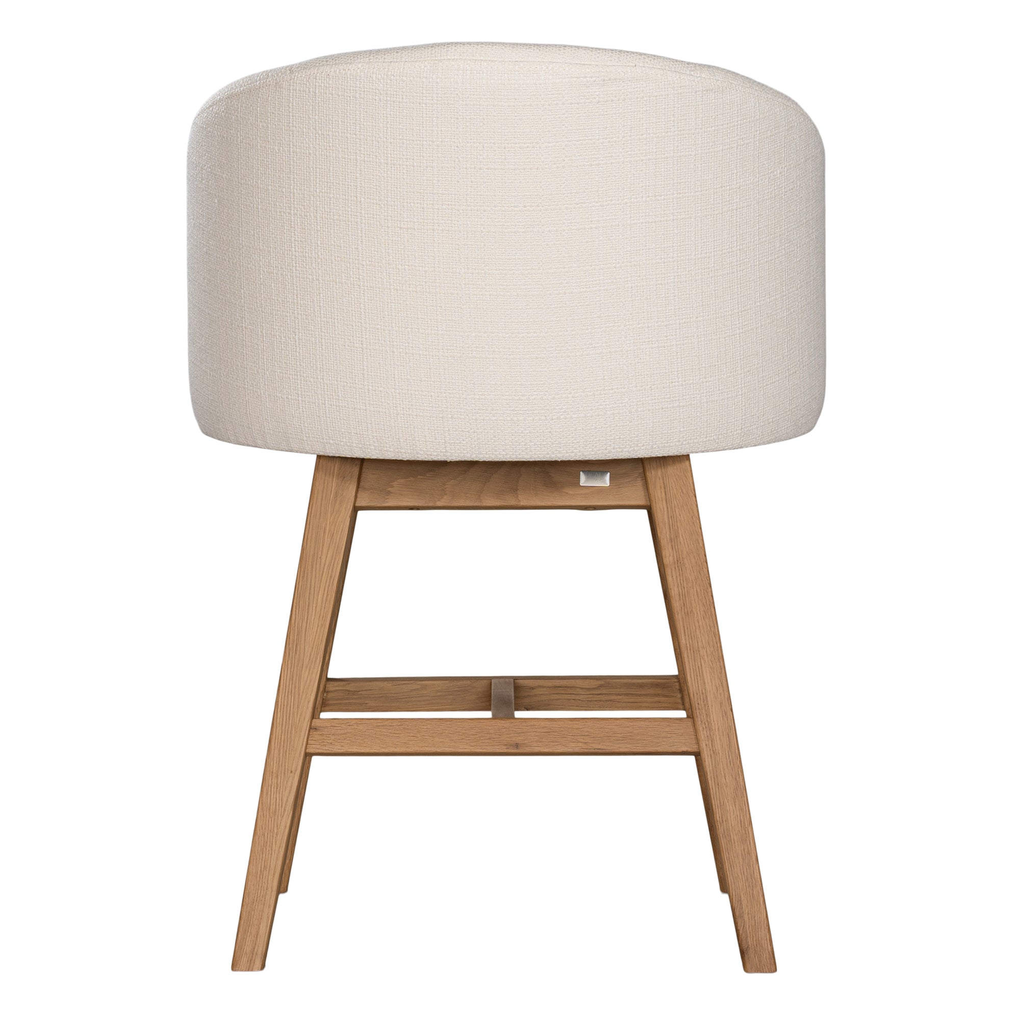 A modern upholstered dining chair featuring a curved backrest and soft white fabric, supported by sturdy oak timber legs with a natural finish
