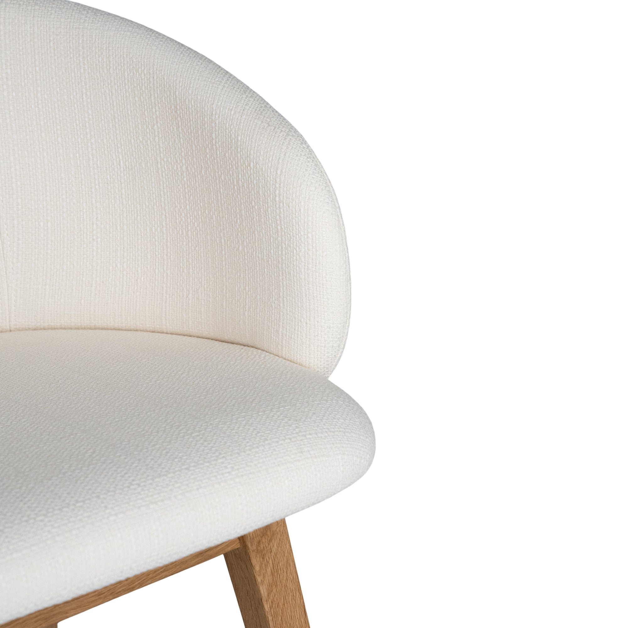 A modern upholstered dining chair featuring a curved backrest and soft white fabric, supported by sturdy oak timber legs with a natural finish