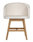 A modern upholstered dining chair featuring a curved backrest and soft white fabric, supported by sturdy oak timber legs with a natural finish