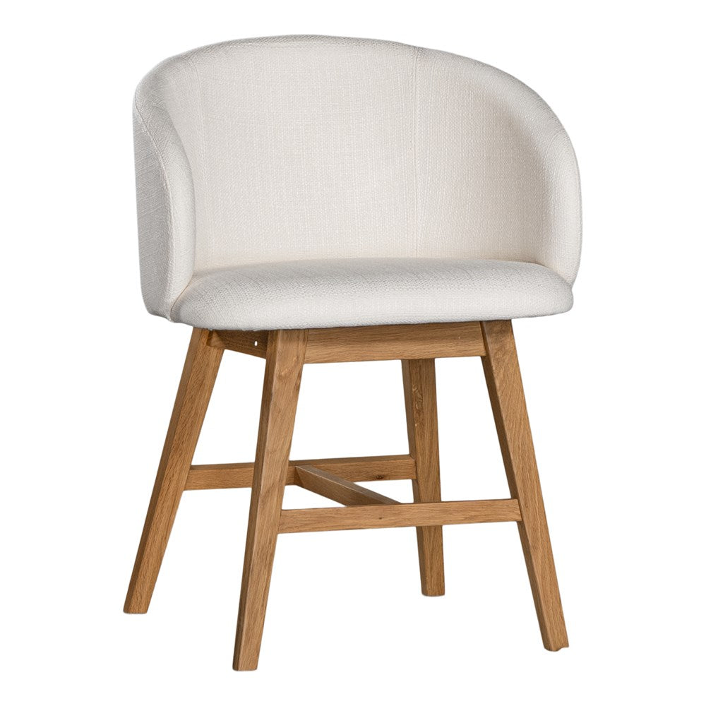 A modern upholstered dining chair featuring a curved backrest and soft white fabric, supported by sturdy oak timber legs with a natural finish