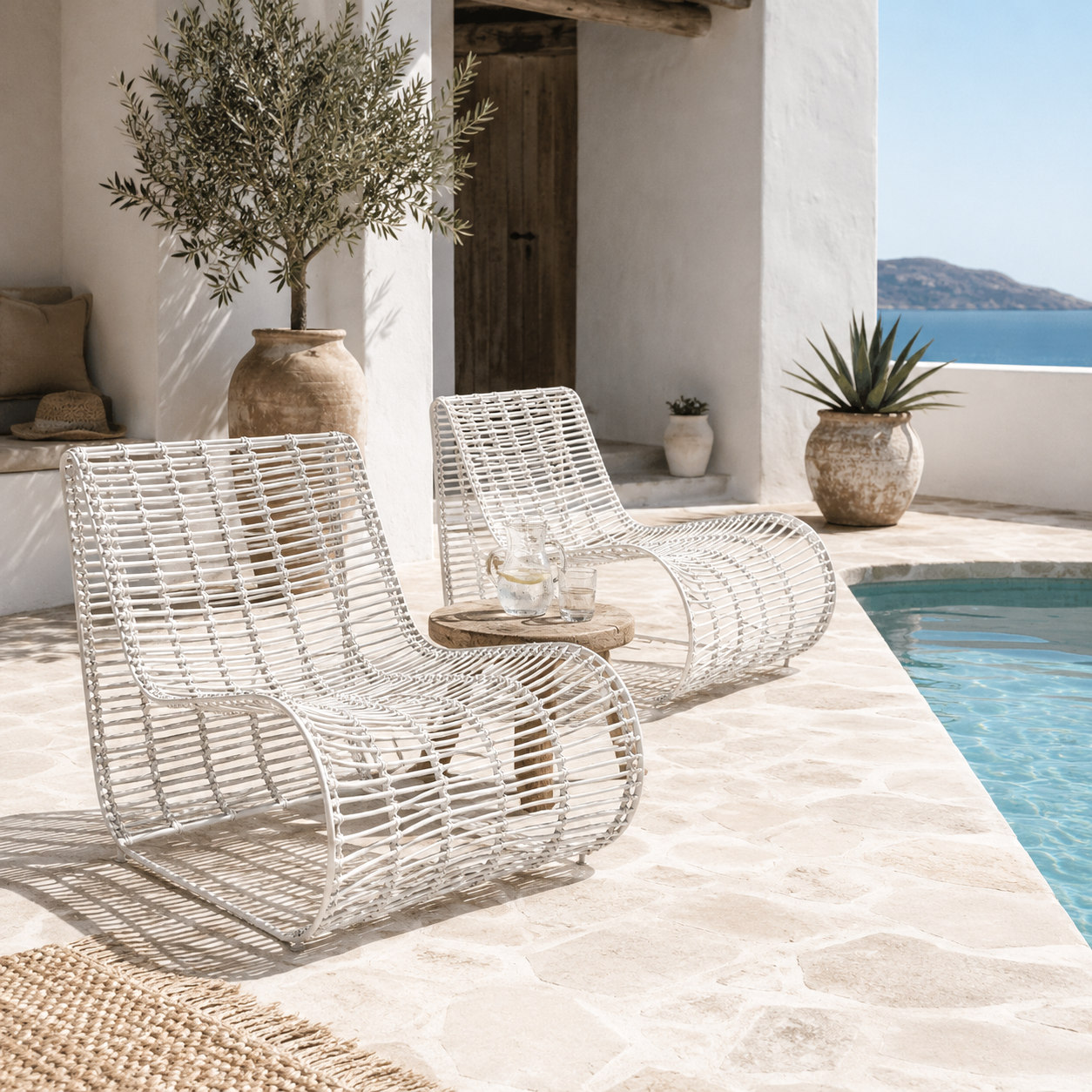 Villa Occasional Chair in white outdoor styled poolside in a Mediterranean inspired resort setting with natural stone, olive trees and coastal views