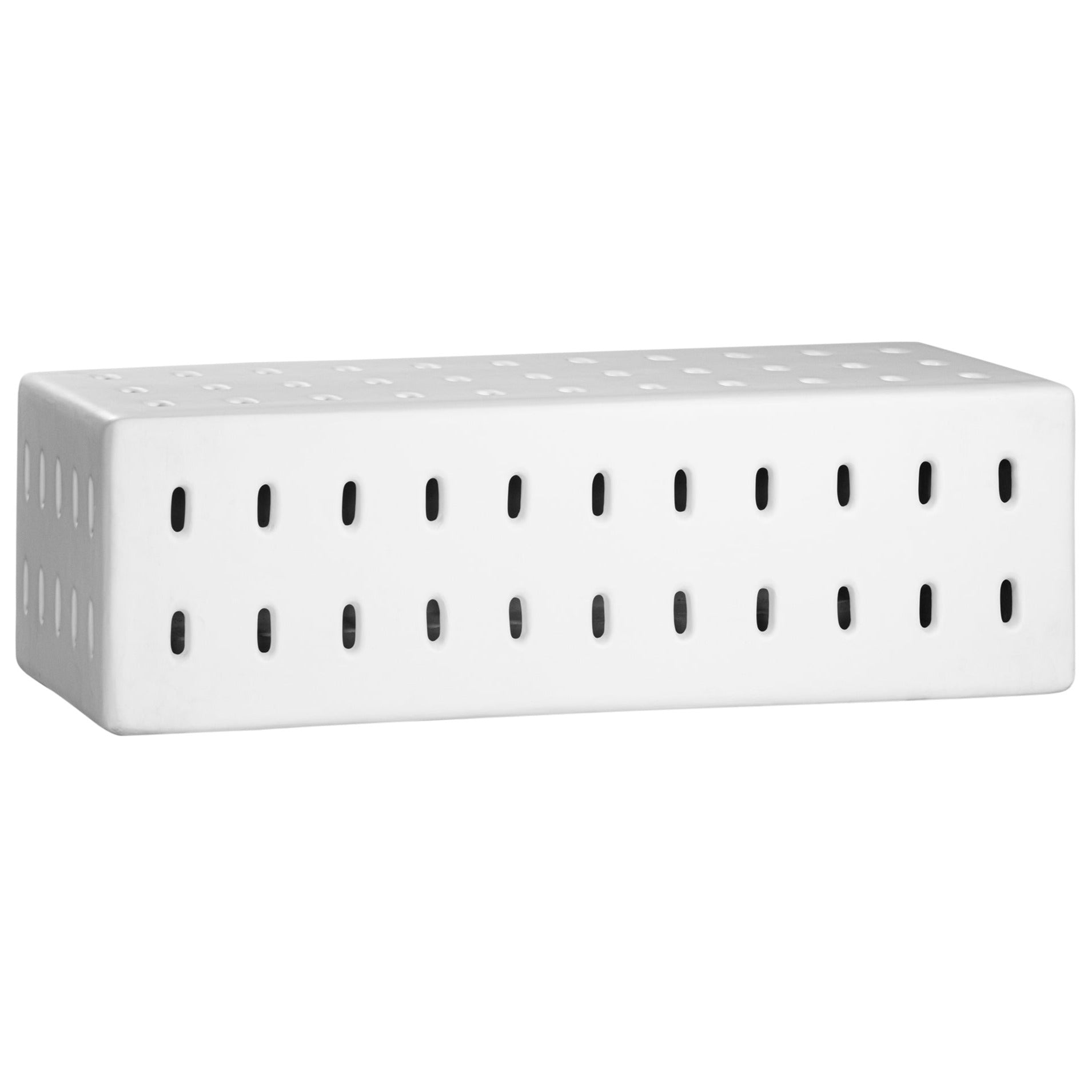 A modern white concrete bench with perforated details, blending sculptural design with functional seating for indoor and outdoor spaces