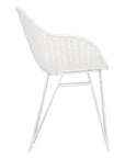 White rattan dining chair with curved back and slim metal legs, perfect for modern and stylish dining settings