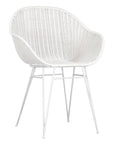 White rattan dining chair with curved back and slim metal legs, perfect for modern and stylish dining settings