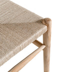 A natural timber wishbone dining chair with a handwoven rope seat, featuring an iconic curved backrest and minimalist Scandinavian-inspired design. Perfect for modern coastal and contemporary interiors, offering both style and comfort