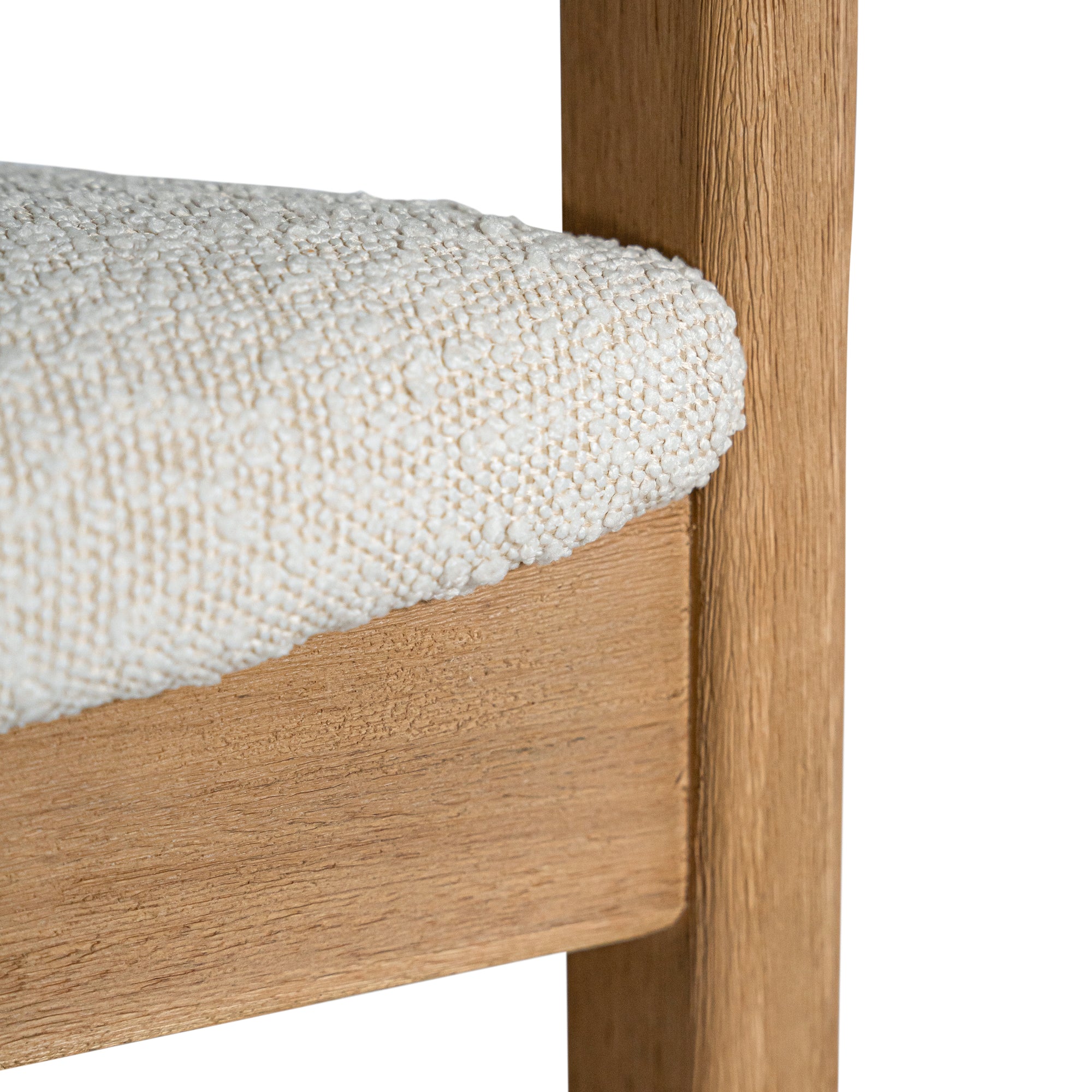 Contemporary wooden dining chair with a natural oak frame and boucle upholstered seat and backrest, designed for modern comfort and style