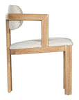 Contemporary wooden dining chair with a natural oak frame and boucle upholstered seat and backrest, designed for modern comfort and style