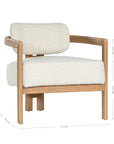 Stylish wooden occasional chair with boucle upholstery, set in a minimalist dining space with a sculptural stone table and an olive tree in a textured planter