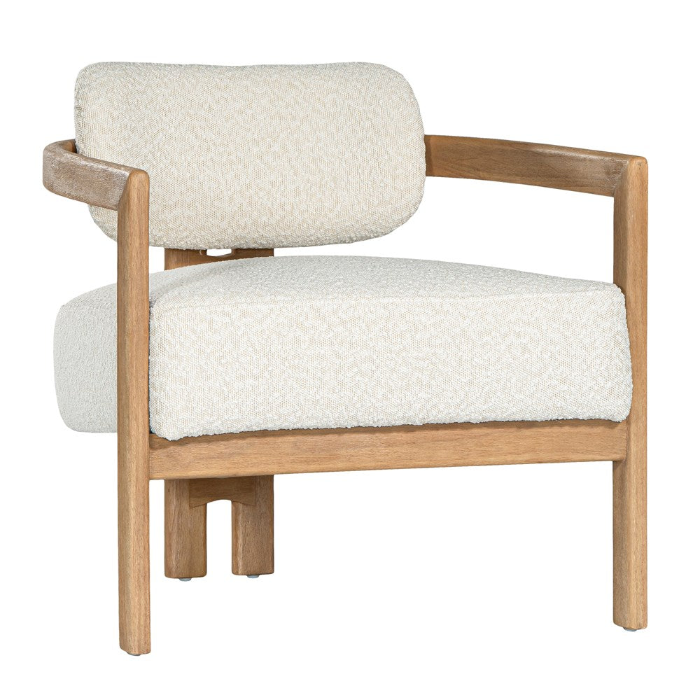 Stylish wooden occasional chair with boucle upholstery, set in a minimalist dining space with a sculptural stone table and an olive tree in a textured planter