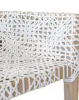 Woven leather armchair with natural wood frame, showcasing intricate handwoven craftsmanship and earthy, relaxed style