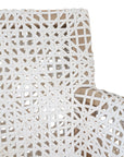 Woven leather armchair with natural wood frame, showcasing intricate handwoven craftsmanship and earthy, relaxed style