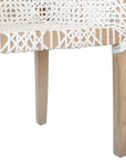 Woven leather armchair with natural wood frame, showcasing intricate handwoven craftsmanship and earthy, relaxed style