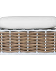 Stylish outdoor rattan ottoman with white cushions, perfect for creating a comfortable and modern alfresco space