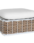 Stylish outdoor rattan ottoman with white cushions, perfect for creating a comfortable and modern alfresco space