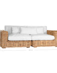 Natural wicker corner chair with thick white cushions, showcasing a coastal-inspired design perfect for indoor and outdoor settings