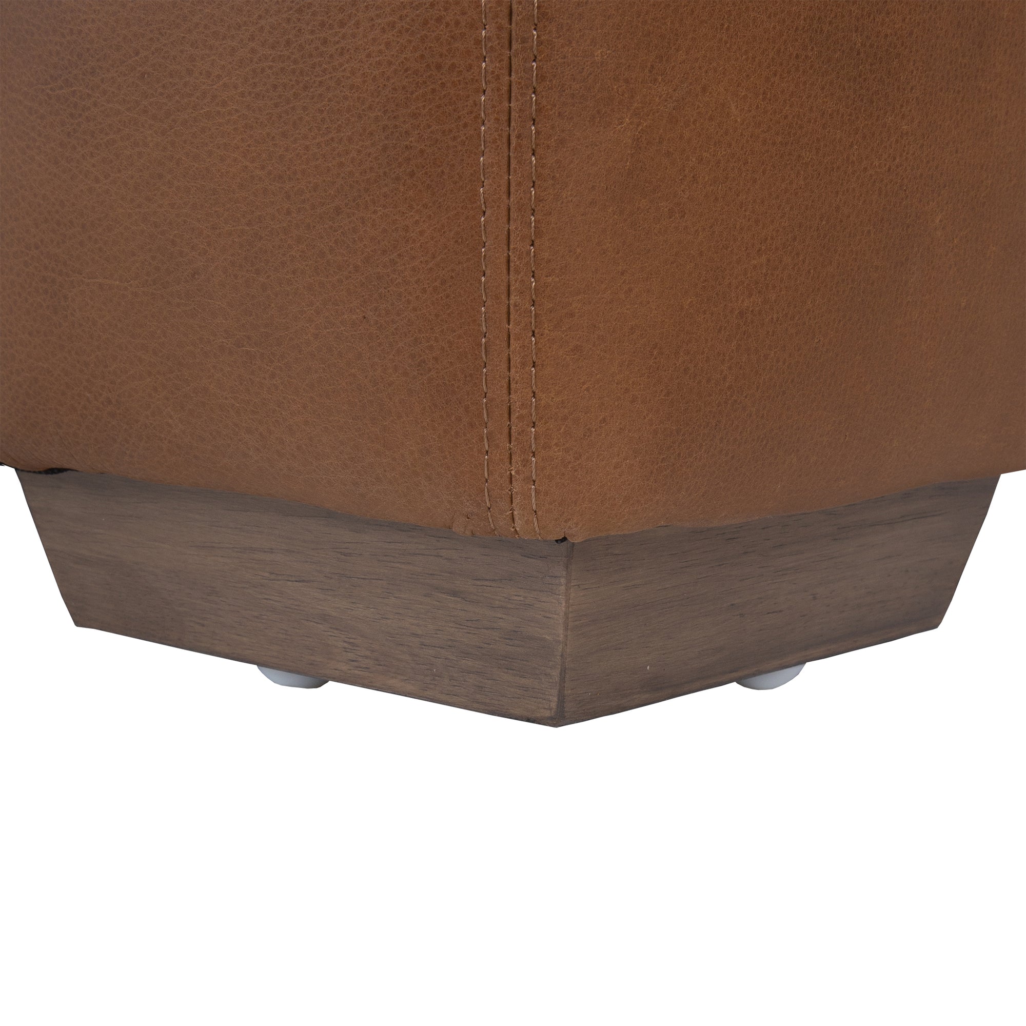 Modern leather upholstered sofa with soft, rounded cushions and light wooden legs