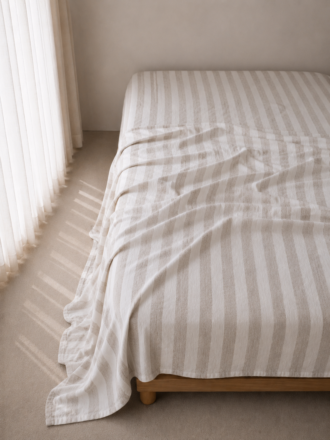 SOL Linen Noemi flat sheet in natural linen fabric, shown on a bed with soft lighting and cozy bedding decor.