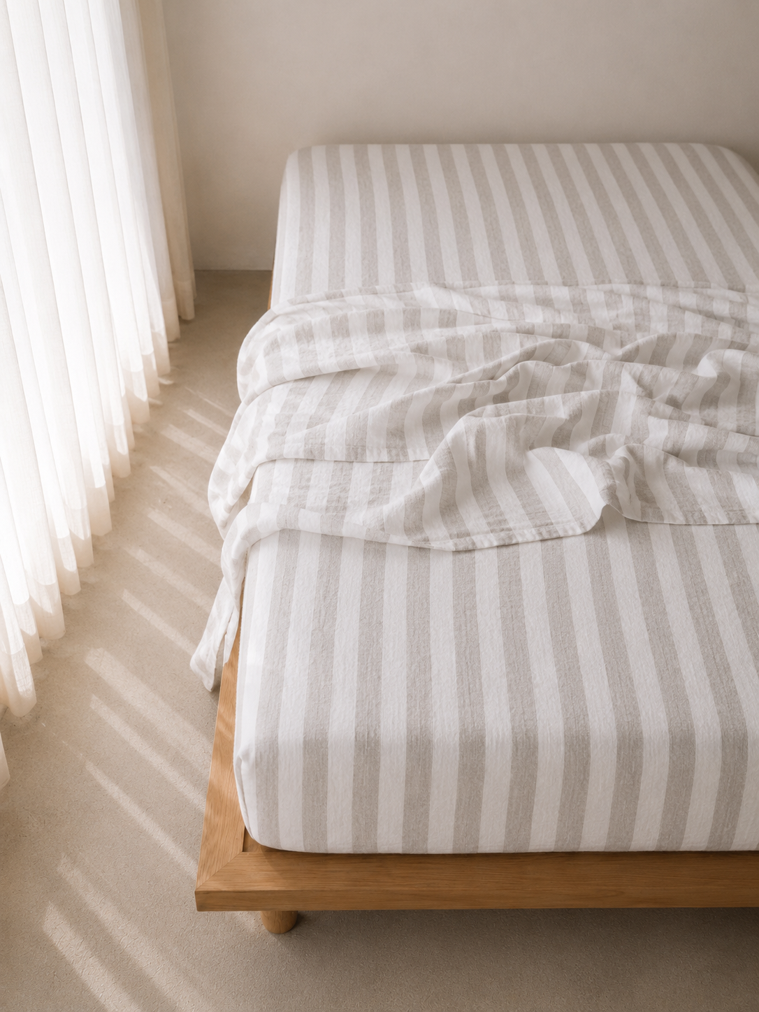 SOL Linen Noemi linen fitted sheet on a bed, showcasing its soft, textured fabric and tailored fit for comfortable bedding.