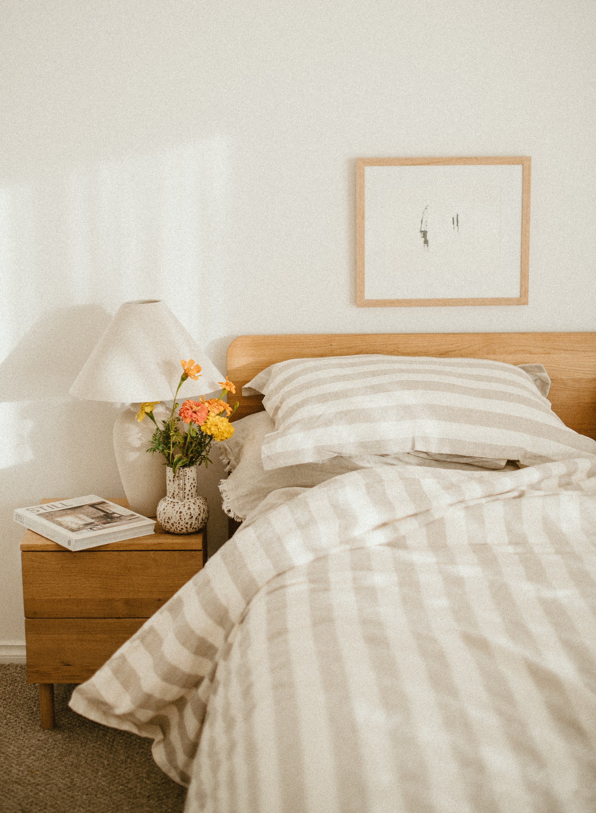 Set of two SOL Linen Noemi linen pillowcases displayed on a bed, showcasing soft, textured beige bedding for a cozy bedroom look.