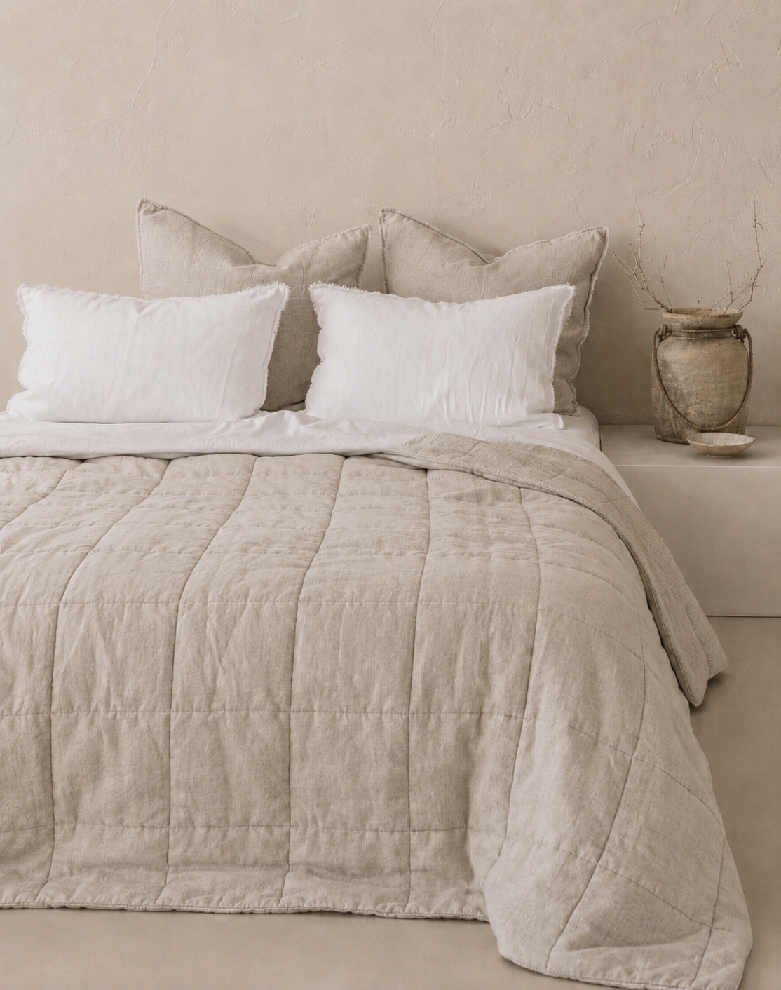 SOL Linen Sable linen quilted coverlet on a bed, showcasing textured bedding with a soft, neutral color for a cozy bedroom look.