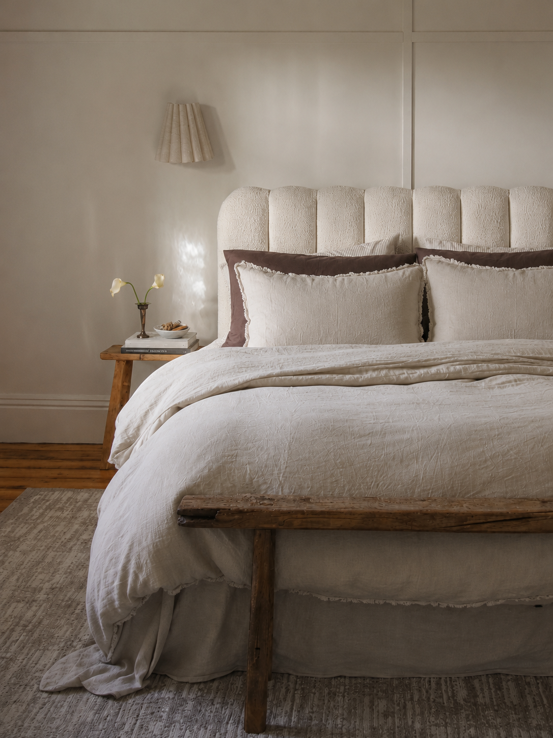 SOL Linen Sable frayed linen duvet cover displayed on a bed with neutral bedding and decor in a cozy bedroom setting.