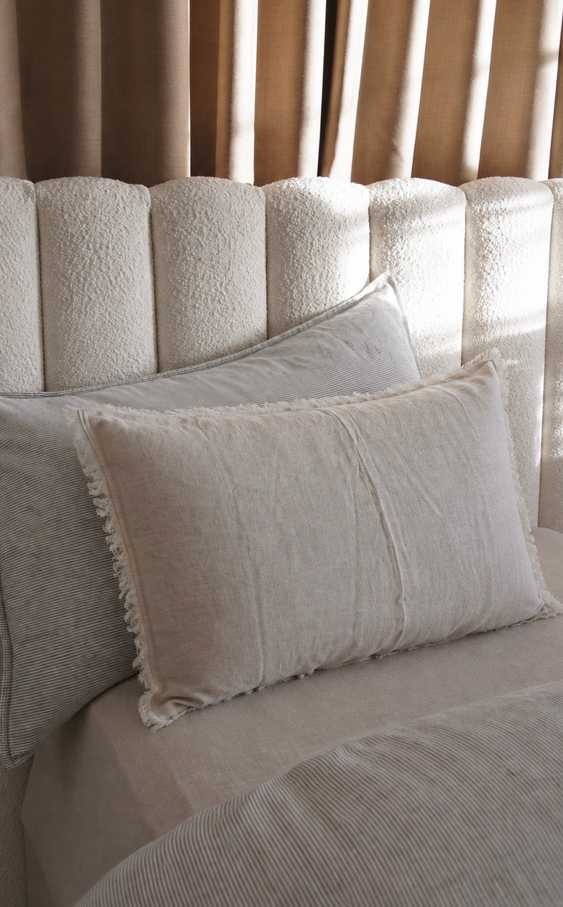 Set of two SOL Linen Sable frayed linen pillowcases for bedding, featuring a soft, natural fabric with frayed edges.